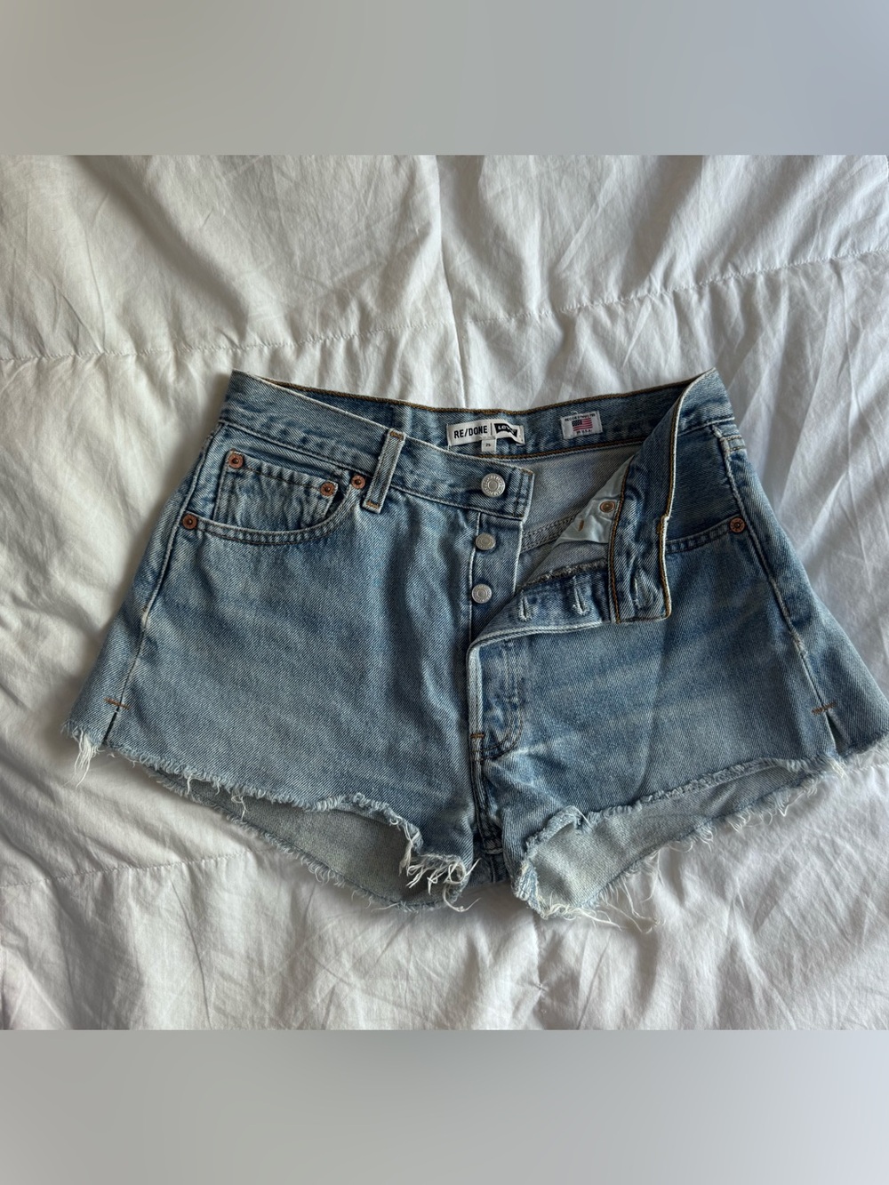 Re/Done Light Wash Frayed Hem Denim Shorts - Size 25